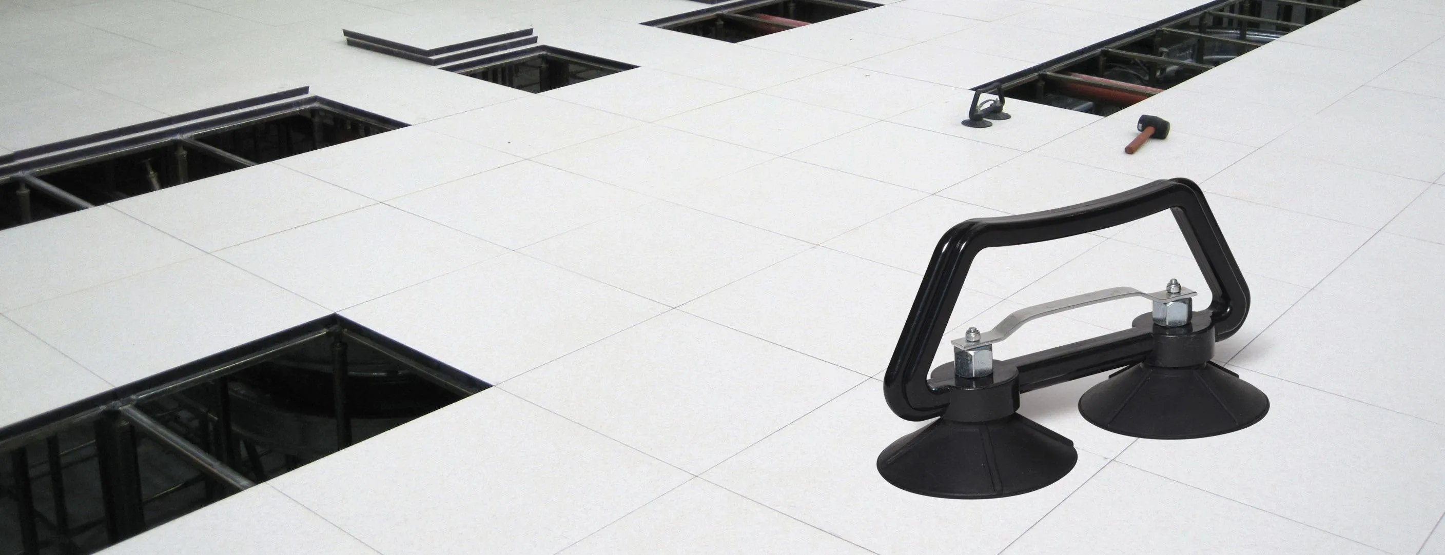 Raised access floor panels and panel lifter